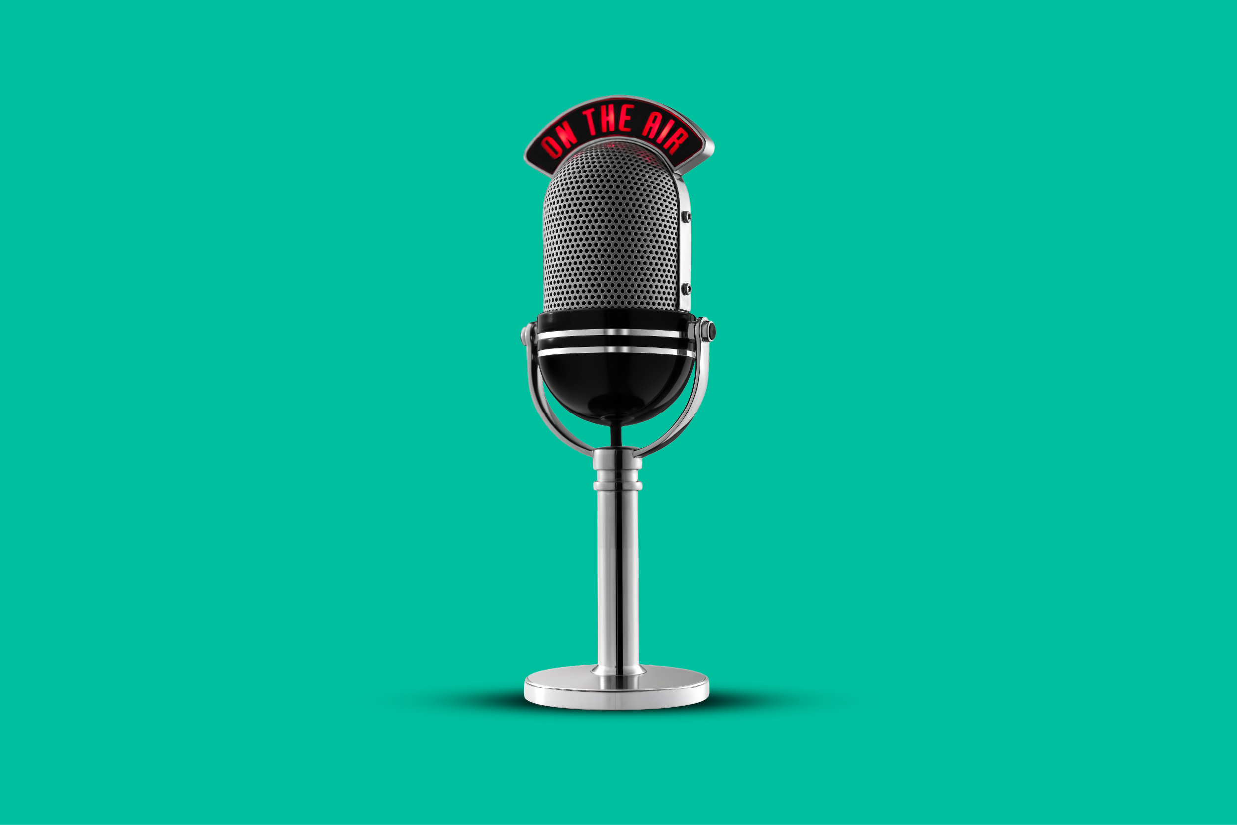 Vintage chrome microphone with an illuminated 'ON THE AIR' sign on a teal background, centered in the frame.