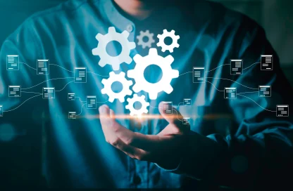 Hands under floating gears and network icons, illustrating automation and connectivity in tech systems