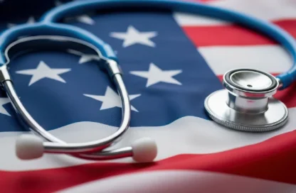 Stethoscope resting on an American flag, symbolizing healthcare in the United States.]
